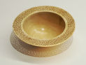 Turned wooden bowl with pierced rim